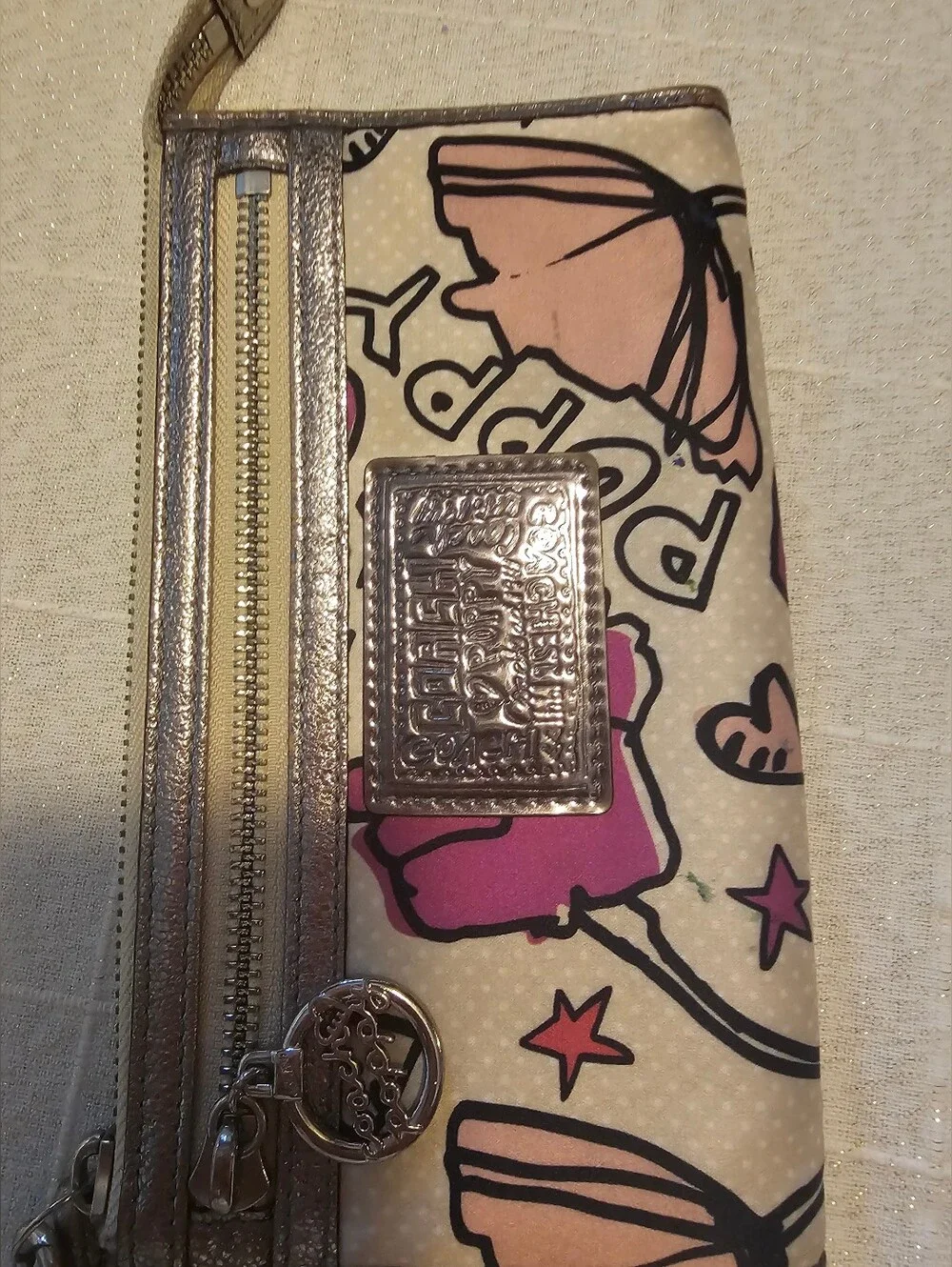 Coach Poppy pink floral graffiti print and metallic silver trim wristlet